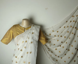 White chettinad saree with gold motifs paired with golden striped blouse - Saree blouse combo