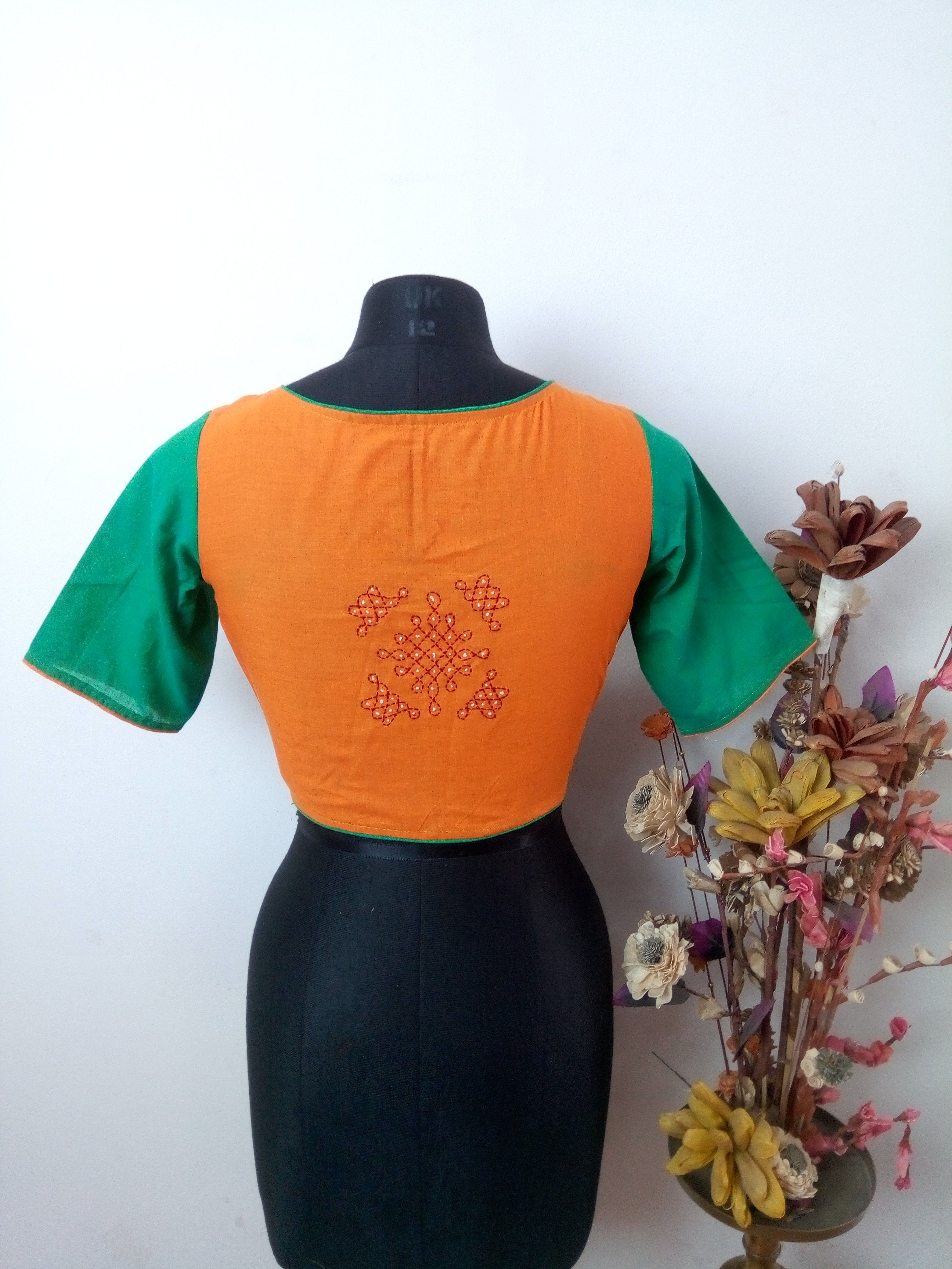 Rangoli embroidery design on the back of the blouse